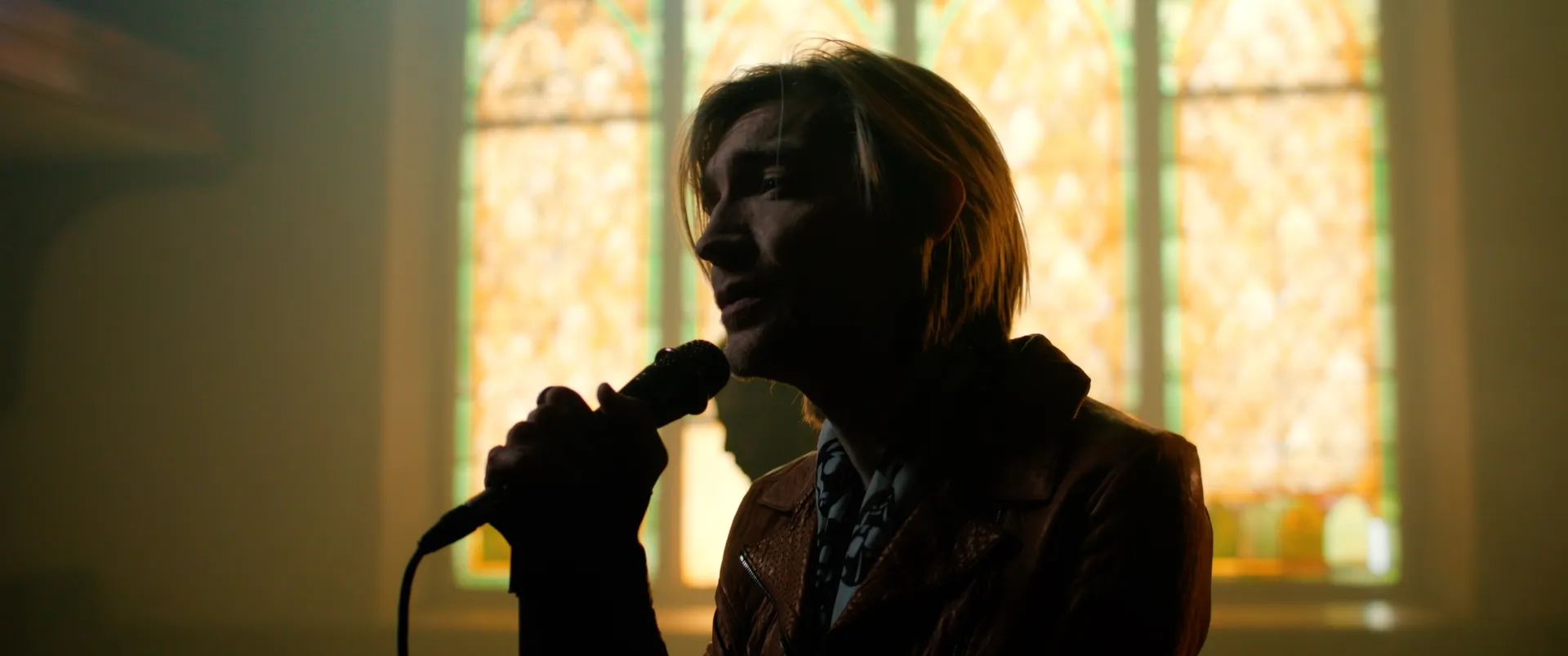 Singing beside the stained glass window